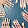 Practice hands with finished gel nail extensions