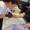 Student giving a manicure during gel nail training