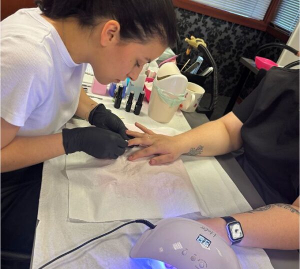 Student giving a manicure during gel nail training