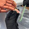 Nail extension being filed on a practice hand