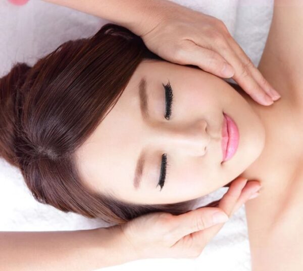Client relaxing during a facial massage