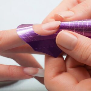 Nail form being fitted for sculpted acrylic nails