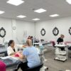 Beauty Academy training room with manicure stations