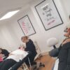 Students practising brow treatments in a training room