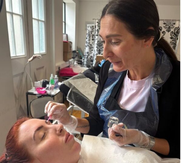 Tutor demonstrating a brow treatment
