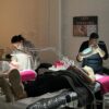 Students giving facials in a training room