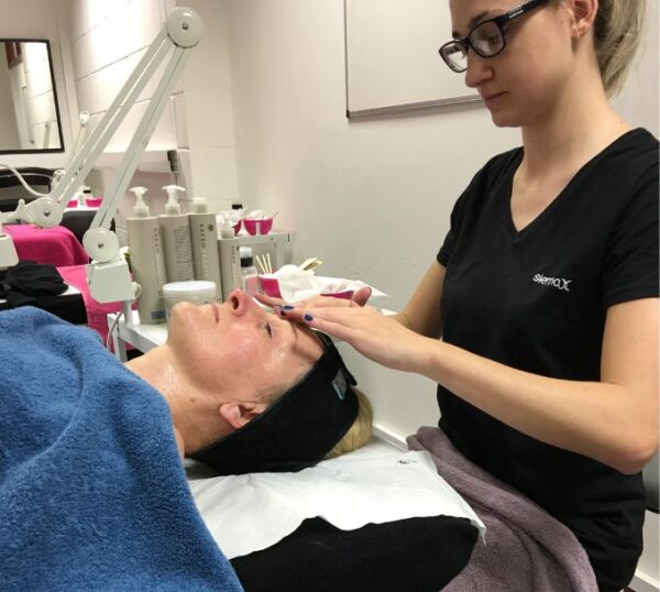 Student giving a facial massage