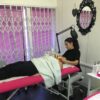 Student giving a facial in a training room