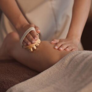 Anti-cellulite massage using a wooden massage tool