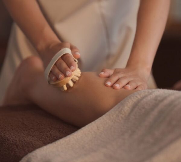 Anti-cellulite massage using a wooden massage tool