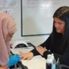 Student practising manicures during training