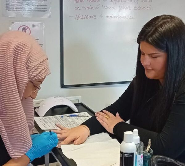 Student practising manicures during training