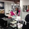 Students practising pedicures in a training room