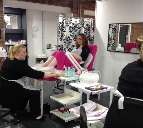 Students practising pedicures in a training room