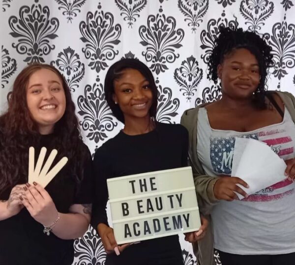 Smiling waxing students holding their spatulas