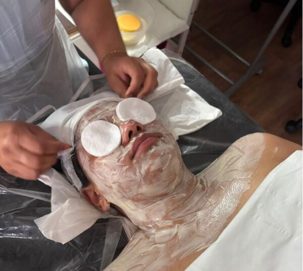 Client receiving a facial mask treatment