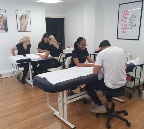 Students training in a Beauty Academy classroom