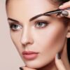 Eyebrow being shaped with tweezers
