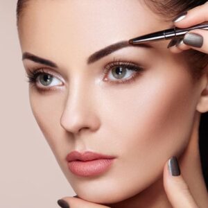 Eyebrow being shaped with tweezers