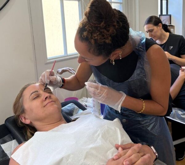 Student shaping a model's brows during training