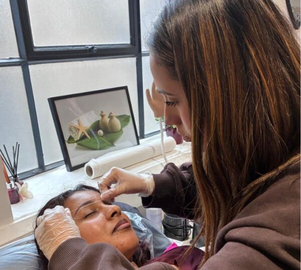 Student concentrating during a brow treatment