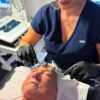 Therapist using a facial electrotherapy machine