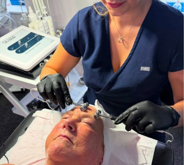 Therapist using a facial electrotherapy machine