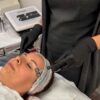 Client receiving an electrical facial treatment