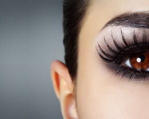 Close-up of a defined brow and dramatic eye make-up