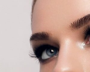Close-up of an eye with full lashes and defined brows