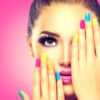Model with colourful nails covering one eye