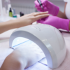 Gel polish manicure being cured under a UV lamp