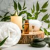 Spa massage setting with towels, candles and plants
