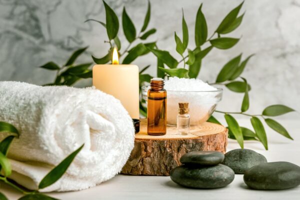 Spa massage setting with towels, candles and plants
