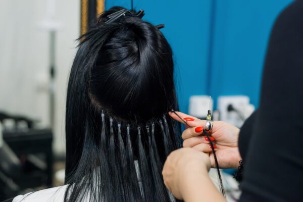Nano ring hair extensions being fitted