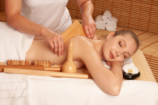 Client receiving a wood therapy body sculpting massage