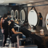 Students at make-up stations in a Beauty Academy training room